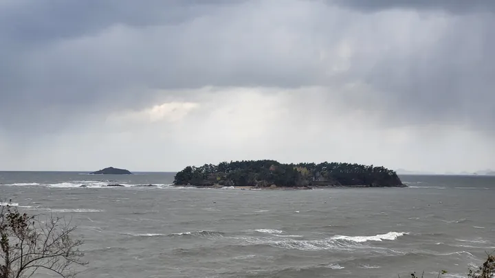 The sea and an island off Byeonsan under a cloudy sky